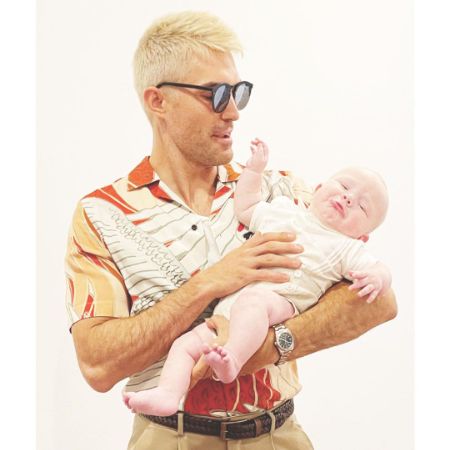 Jacob Jules Villere's husband, Peter Porte, carrying a baby with bleached blond hair.